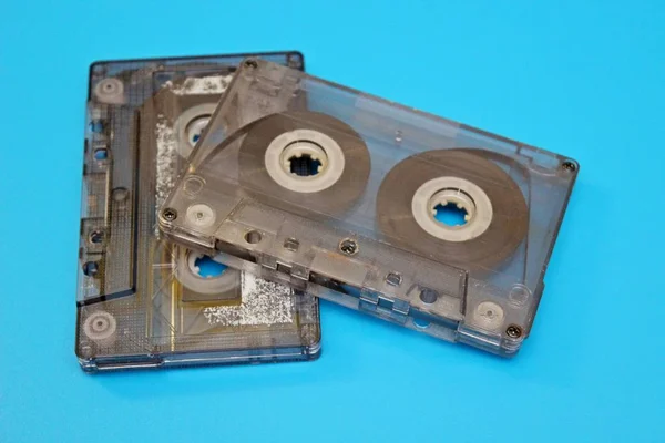 Old audio cassettes located on a blue background