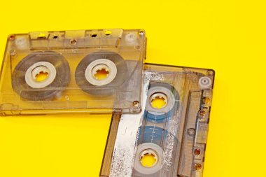 Sarı arka plan üzerine serilmiş eski ses kasetleri