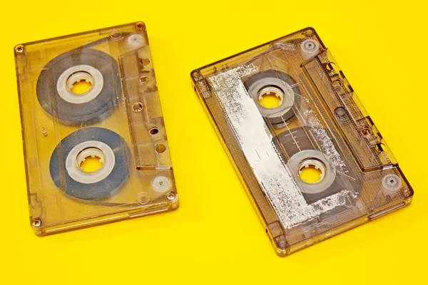 Old audio cassettes laid out on a yellow background — Stock Photo, Image