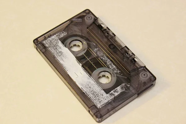 Old audio cassette lehit on a yellow background — Stock Photo, Image