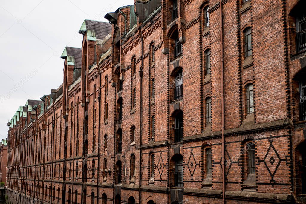 Old red brick building facade with windows