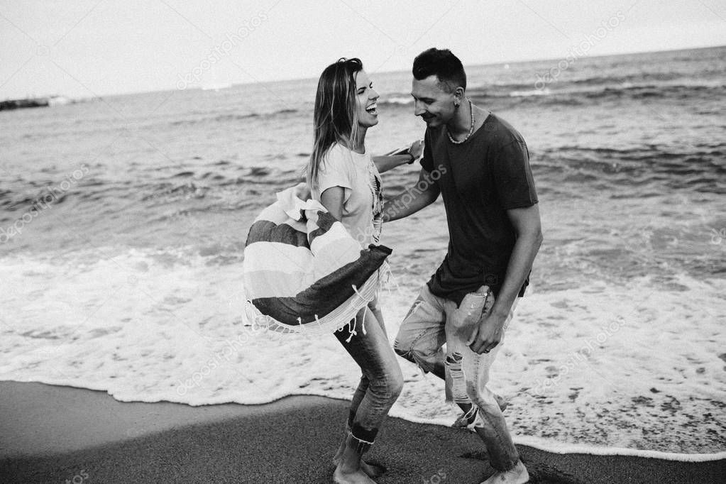 Happy couple in love walking on the beach