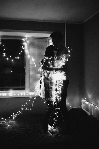 Loving Couple Hug Each Other Garland Bedroom Black White Photo — Stock Photo, Image