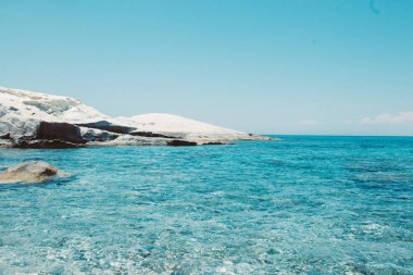 Stones and rocks formations by the sea at Sarakiniko area on Milos island, at Aegan sea, Greece. Moon Landscape. clipart