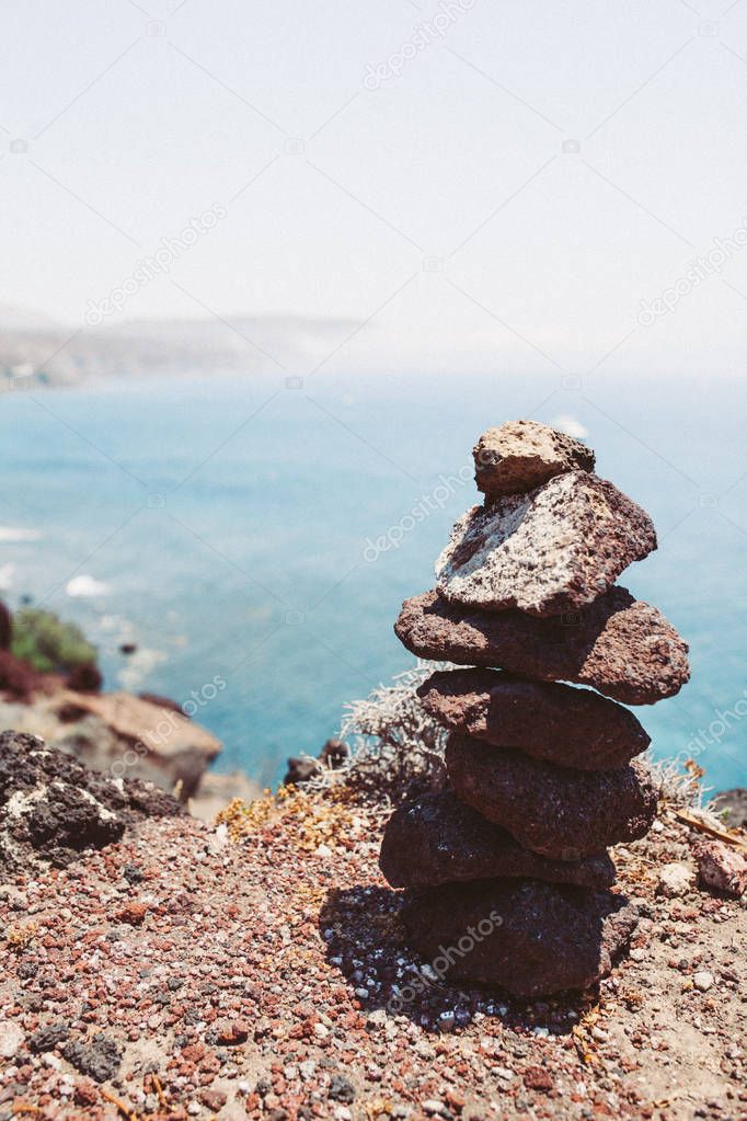 Zen Stones / Stones pyramid on sand. Ocean in the background - vintage filter