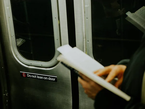 Man reading a book in the train