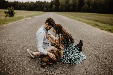 Köpek yeşil alanda ile sarılma aşık genç çift portresi