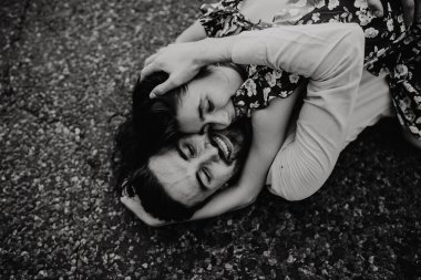 Yürüyüş ve çayırda sarılma aşık genç bir çift. Siyah ve beyaz fotoğraf.