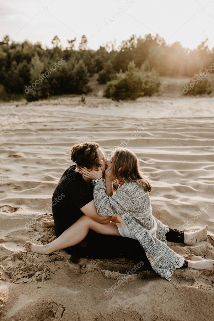 Young ,happy  couple kissing  on the beach 