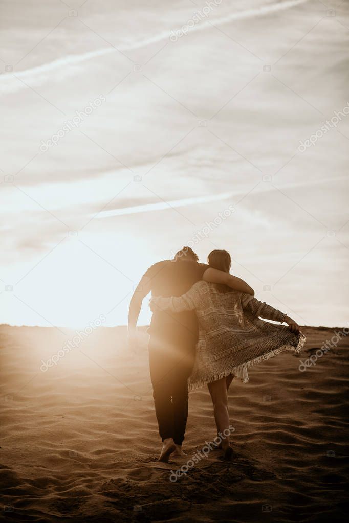 happy couple in love spend good time on the beach and enjoy each other