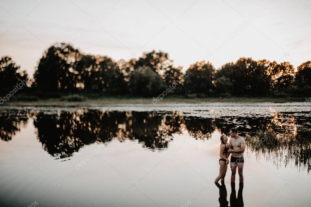 Young couple hugging  in the lake