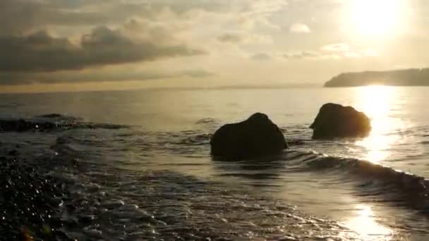 Havet med stenig strand på gyllene timmen — Stockvideo