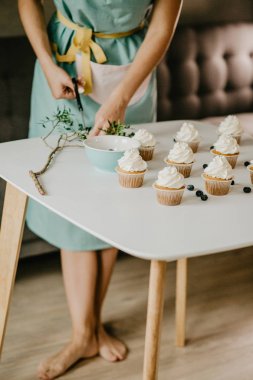 woman in apron cooking dessert
