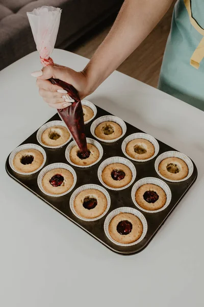 woman in apron cooking dessert