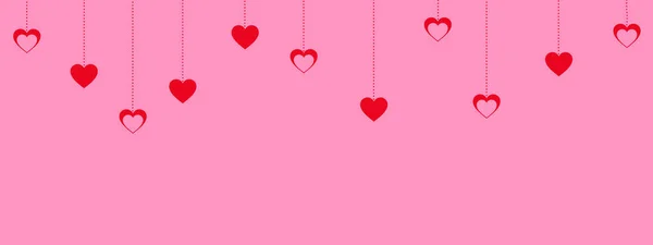 Ροζ φόντο ημέρα του Αγίου Βαλεντίνου με αναρτημένα κόκκινες καρδιές — Φωτογραφία Αρχείου