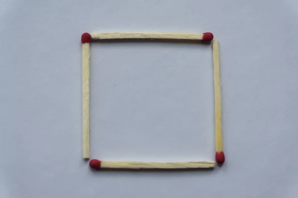 A square of matches on a white background. Top view. Mock up. Flat lay compositio