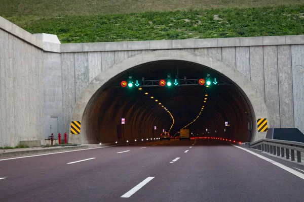 Motorway highway tunnel entrance,traffic warning signs
