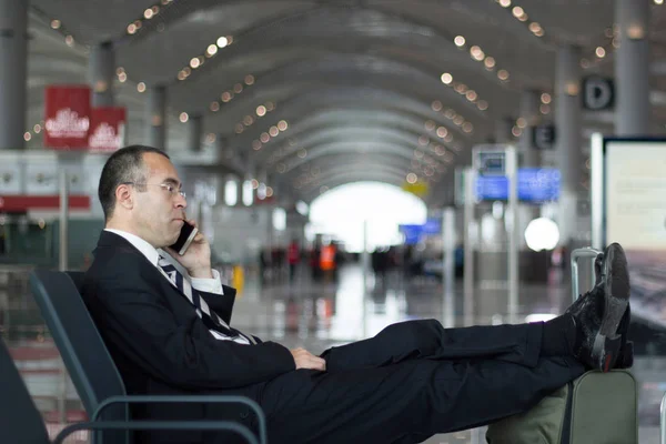 Business man at the airport talking with phone