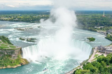 Niagara Falls, üzerinde / Kanada - 09/06/2018: Niagara Şelaleleri kaldırım ve bir tekne ile turistler şelaleyi yakınındaki boyunca yürüyüş insanlar ile geniş hava görünümünü
