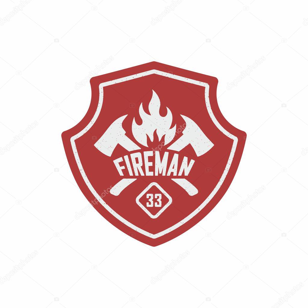 Color illustration of a red shield, text, crossed axes, fire on a white background. Vector illustration of a firefighter logo in vintage style with grunge texture.
