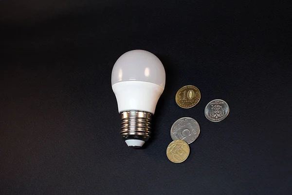 Electric and energy saving light bulb and money, economy concept.