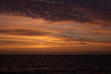 Denizde gün batımı, güzel bulutlar, arka plan.