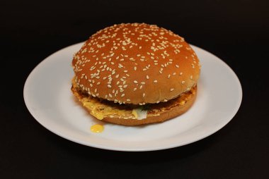 Zararlı burger, koyu bir arka plan üzerinde fast food.