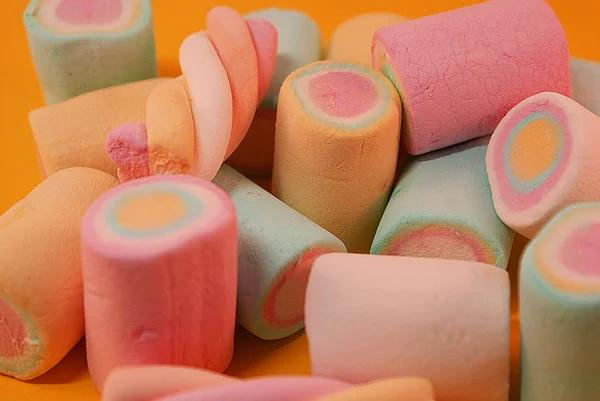 Close-up of pastel colored marshmallows on a bright background.