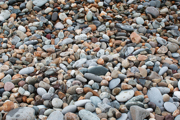 Stones by the sea, pebbles on the beach, sea coast.