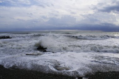 Fırtına, güçlü dalgalar, deniz kıyıları, kumsalda çakıl taşları.