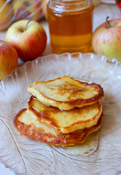Fried pancakes with apple and honey
