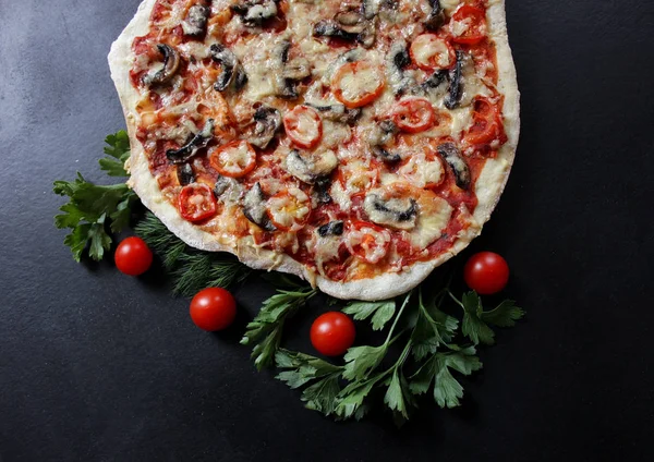 vegetable pizza with mushrooms and cheese on black