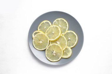 Beyaz bir adam üzerinde gri bir plaka üzerinde limon dilimleri