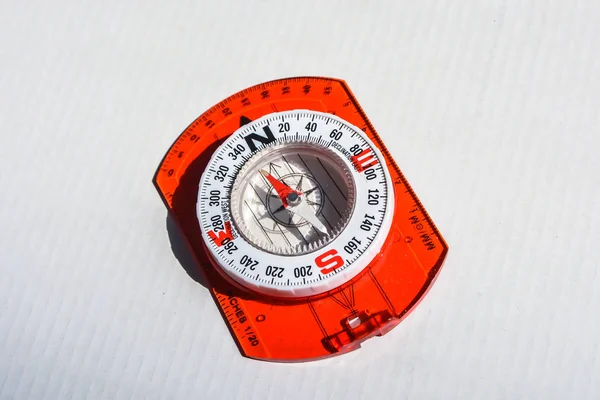 Navigation equipment for orienteering. Compass on white background.