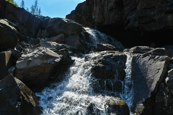 Putorana Plateau, a waterfall on the Grayling Stream. Mountain stream on a  cloudy day Stock Photo - Alamy