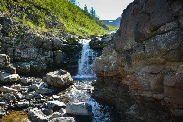 Putorana Plateau, a waterfall on the Grayling Stream. Mountain stream on a  cloudy day Stock Photo - Alamy