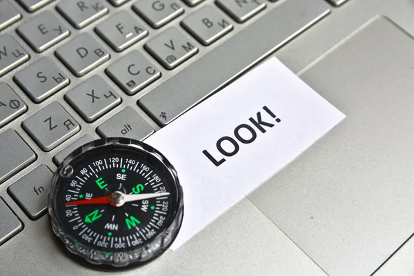 Navigation on the Internet! Photo of magnetic compass on computer keyboard.