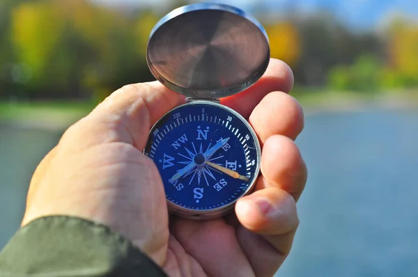 Walking with a compass in his hand. — Stock Photo, Image