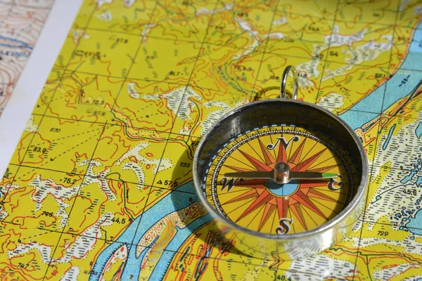 Compass and map. Navigation tools so as not to get lost.