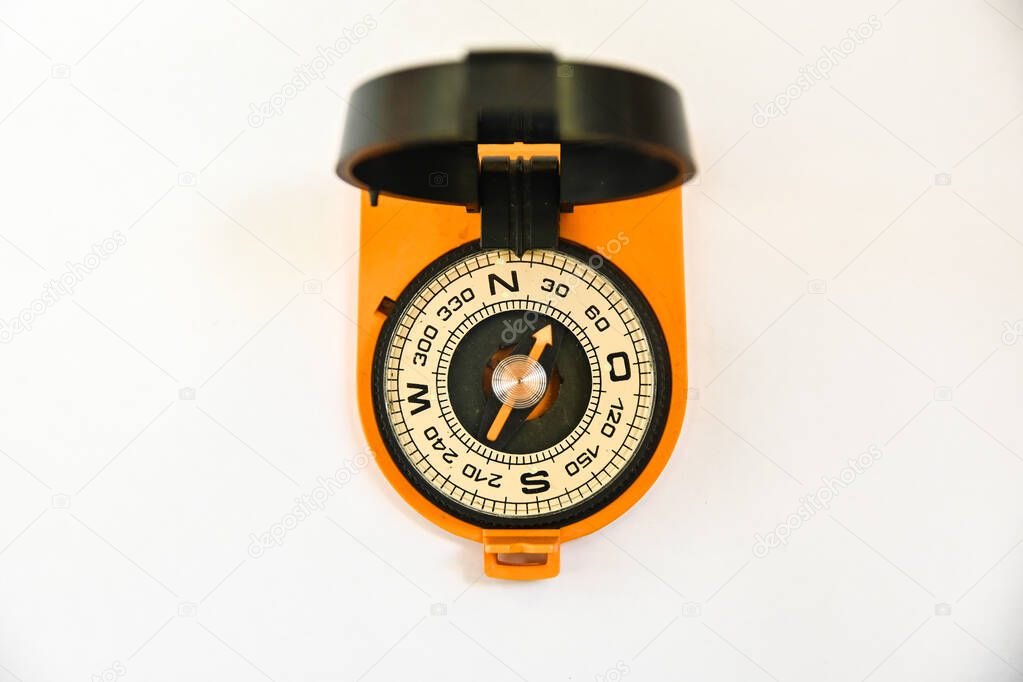 Compass. Magnetic compass, a navigation tool is located on a white background.