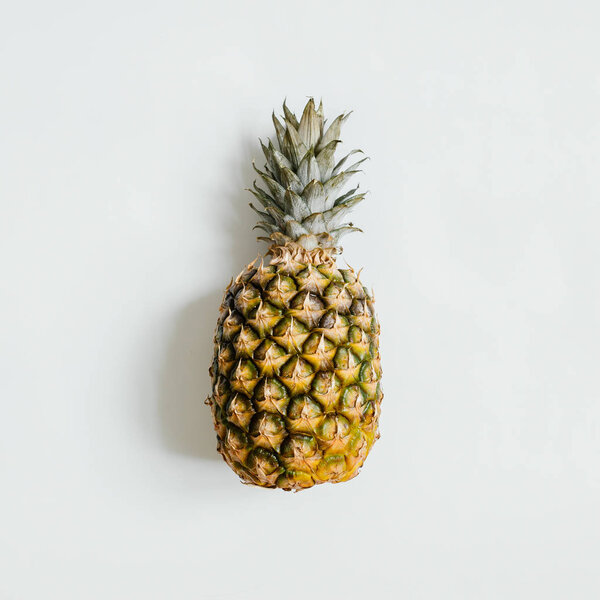 Ripe pineapple on white background isolated. Minimalist style trendy tropical concept.