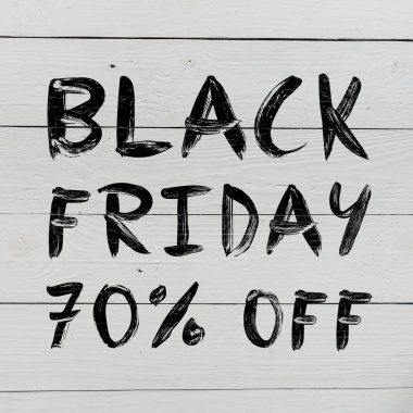Black friday 70% off brush hand lettering on white painted rustic barn wooden planks. Sale banner. clipart