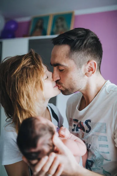 Happy Parents Holding Small Baby Kissing Each Other — Stock Photo, Image