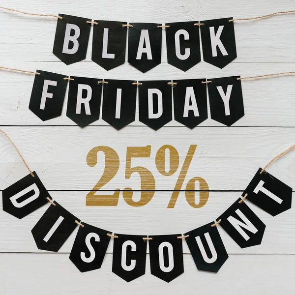 Cuma yirmi beş yüzde indirim Kağıt afiş garland beyaz barn tahtaya asılı yazı plakalar arka plan siyah. Kare tatil lüks el ilanı.