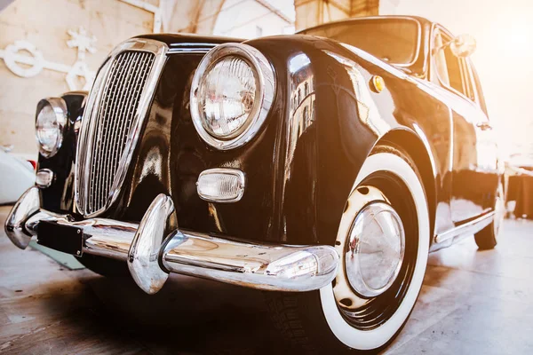 Front view of classic vintage car. Retro toned postcard, poster.