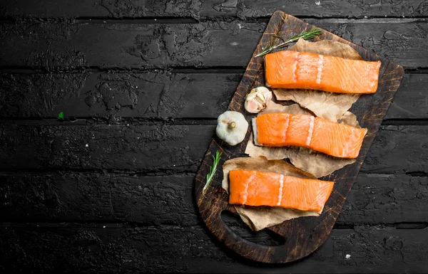 Raw salmon fish filet with spices.