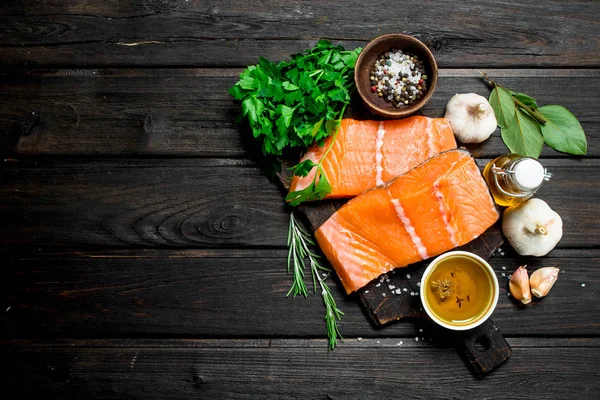 Raw salmon fish filet with spices and herbs.