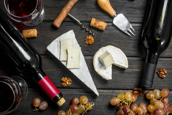 Brie cheese with red wine, nuts and grapes.
