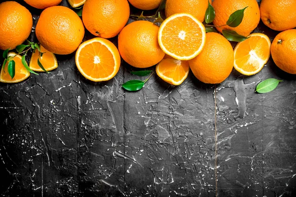 Fresh ripe oranges with leaves.