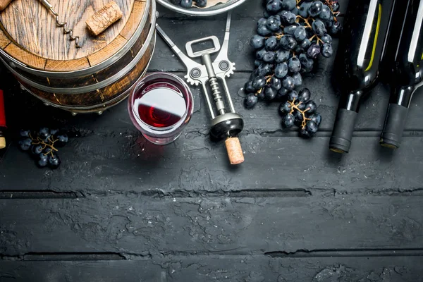 Wine background. Red wine with grapes and an old barrel.